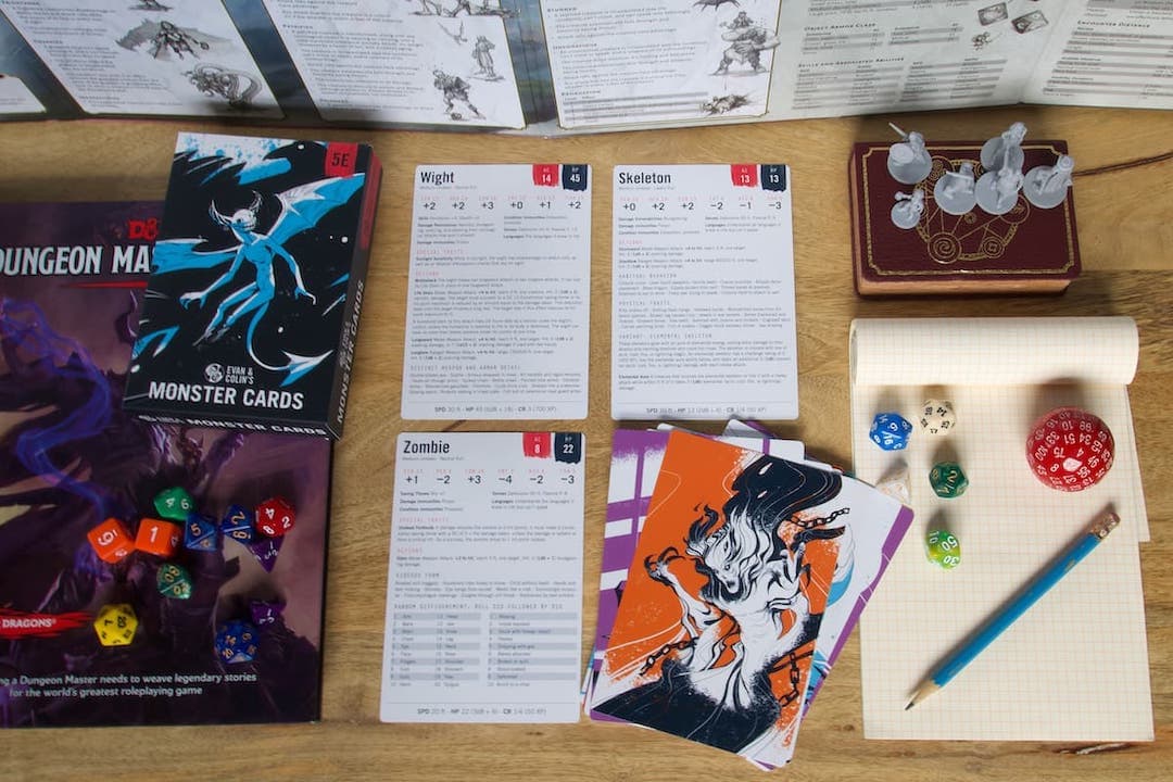 Table with 5E Dungeon Master Screen and Monster Cards